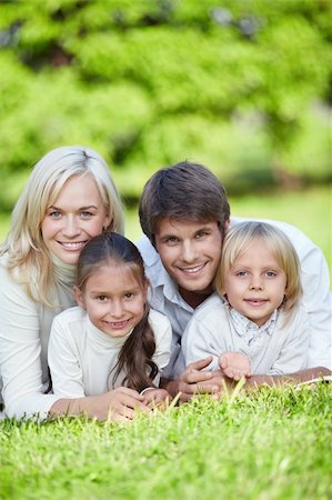 simsearch:400-04654326,k - Young happy family with kids in the park Stock Photo - Budget Royalty-Free & Subscription, Code: 400-04377572