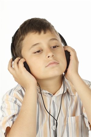 Boy with headphones listening to music over white Stock Photo - Budget Royalty-Free & Subscription, Code: 400-04377959