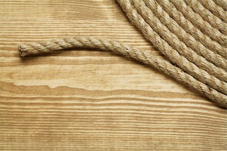 simsearch:400-06106317,k - Roll of rough rope on wooden background Photographie de stock - Aubaine LD & Abonnement, Code: 400-04378173