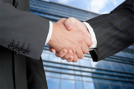 simsearch:400-07301842,k - closeup of business people shaking hands over a deal Fotografie stock - Microstock e Abbonamento, Codice: 400-04379485
