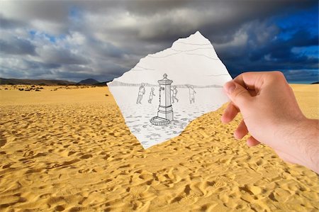 hand holds paper with sketch the fontanelle of water in the middle of the desert Foto de stock - Royalty-Free Super Valor e Assinatura, Número: 400-04379835