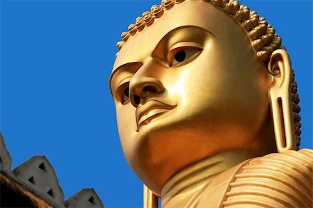 The giant golden Buddha statue sitting on the roof of the Golden Temple in Dambulla, Sri Lanka. Built in 2001 it is said to be the largest of its kind in the world. Stock Photo - Budget Royalty-Free & Subscription, Code: 400-04370124