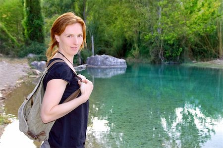 Hiker woman smiling backpack nature river lake trees redhead Stock Photo - Budget Royalty-Free & Subscription, Code: 400-04370950