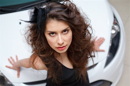 Young woman on white hood of New car Stock Photo - Budget Royalty-Free & Subscription, Code: 400-04371346