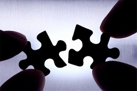 puzzle pieces hand - two puzzle pieces getting connected Stock Photo - Budget Royalty-Free & Subscription, Code: 400-04371365