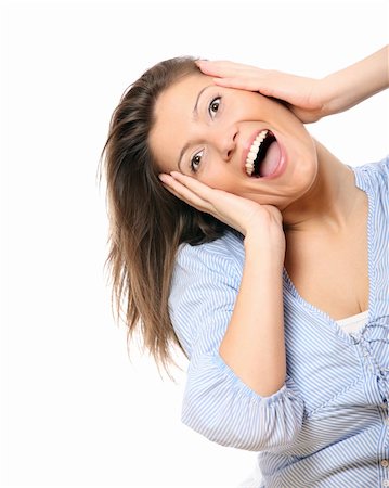 A portrait of a beautiful young surprised woman with long hair holding her head over light background Stock Photo - Budget Royalty-Free & Subscription, Code: 400-04371947