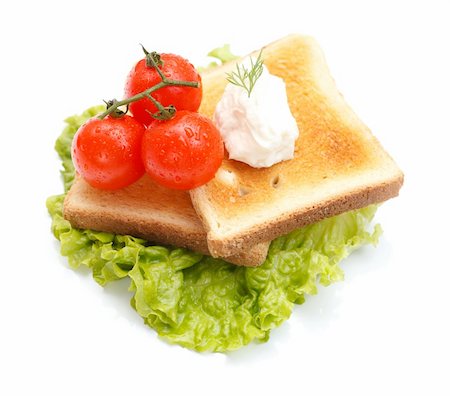 Toast bread with cream cheese and tomatoes on a fresh leaf of lettuce Foto de stock - Royalty-Free Super Valor e Assinatura, Número: 400-04372098