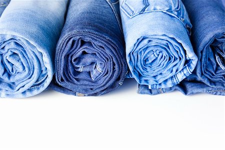 simsearch:400-07770306,k - Rolls of Blue Jeans isolated on white background with copy space for your text Foto de stock - Royalty-Free Super Valor e Assinatura, Número: 400-04372161