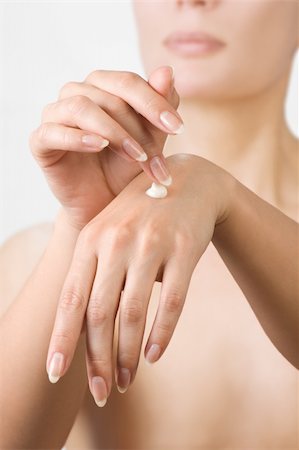 simsearch:400-04127590,k - Woman hands applying moisturizing cream to her skin.Shallow focus Stock Photo - Budget Royalty-Free & Subscription, Code: 400-04372825