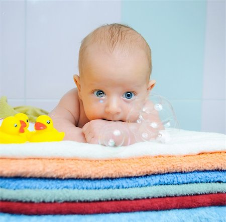 Little cute baby boy with soap bubbles lying on colorful towels Stock Photo - Budget Royalty-Free & Subscription, Code: 400-04372846