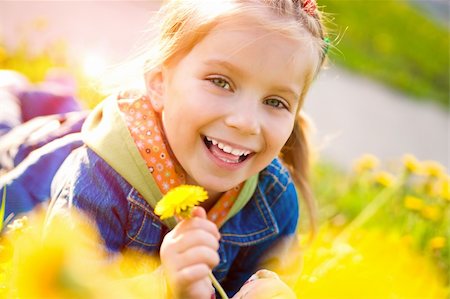 spring landscape kids - Cute little girl  on the meadow in spring day Stock Photo - Budget Royalty-Free & Subscription, Code: 400-04384177