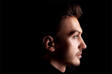 simsearch:400-06916704,k - Young man's portrait. Close-up face against black background Stock Photo - Budget Royalty-Free & Subscription, Code: 400-04384598