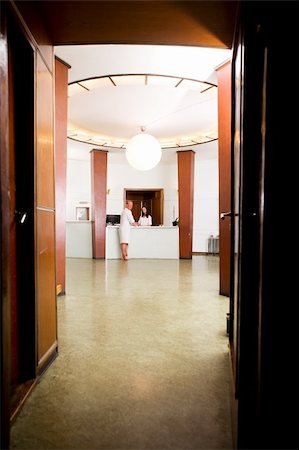 A man standing at a spa reception with a bathrobe on Stock Photo - Budget Royalty-Free & Subscription, Code: 400-04384629