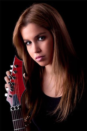 simsearch:400-06750158,k - beautiful young woman with a electric guitar, on black, studio shot Foto de stock - Royalty-Free Super Valor e Assinatura, Número: 400-04385626