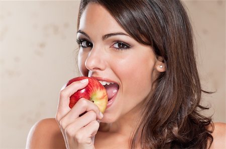 Portrait of pretty young woman eating an apple Stock Photo - Budget Royalty-Free & Subscription, Code: 400-04386081