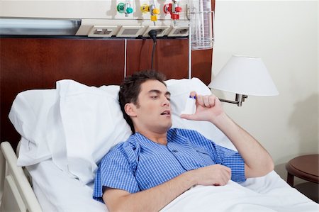 Asthmatic male patient on bed using asthma inhaler Stock Photo - Budget Royalty-Free & Subscription, Code: 400-04386475
