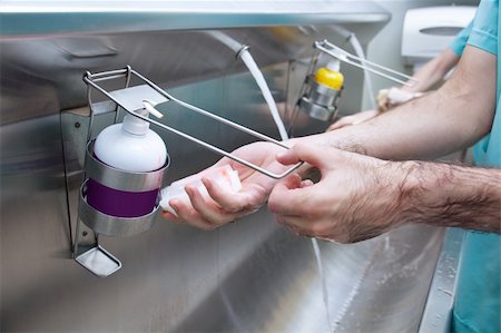 doctor washing hands - Cropped image of man washing his hand with hand sanitizer Stock Photo - Budget Royalty-Free & Subscription, Code: 400-04386471