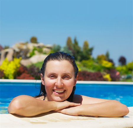 swimming pool leaning on edge - A young attractive woman in a swimming pool Stock Photo - Budget Royalty-Free & Subscription, Code: 400-04387336