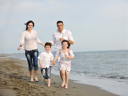 happy young family have fun and live healthy lifestyle on beach Stock Photo - Budget Royalty-Free & Subscription, Code: 400-04387422