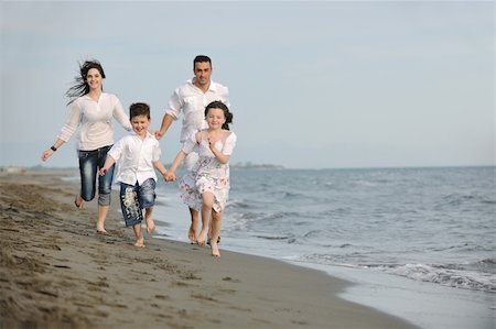 happy young family have fun and live healthy lifestyle on beach Photographie de stock - Aubaine LD & Abonnement, Code: 400-04387423