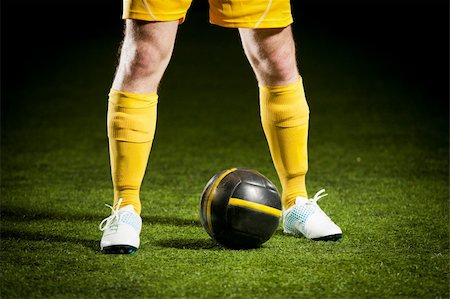 simsearch:400-06513403,k - Close up of a soccer ball and a feet of a soccer player Stock Photo - Budget Royalty-Free & Subscription, Code: 400-04387444