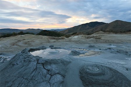 Strange landscape (dry mud, scorched earth) produced bu active mud volcanoes. Location: Romania, Buzau county. Foto de stock - Royalty-Free Super Valor e Assinatura, Número: 400-04389411