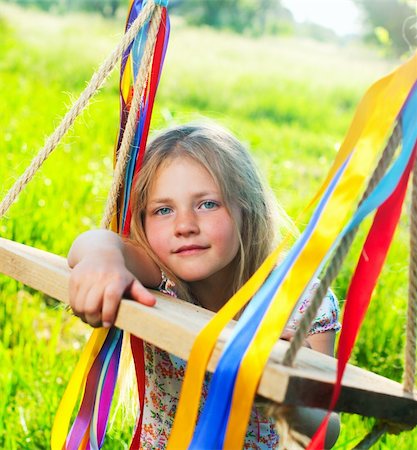 simsearch:400-07615708,k - Young cute girl on swing with ribbons in the garden Stock Photo - Budget Royalty-Free & Subscription, Code: 400-04389482