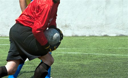 simsearch:400-03929924,k - Red dressed football goalkeeper with ball in hand Photographie de stock - Aubaine LD & Abonnement, Code: 400-04389681