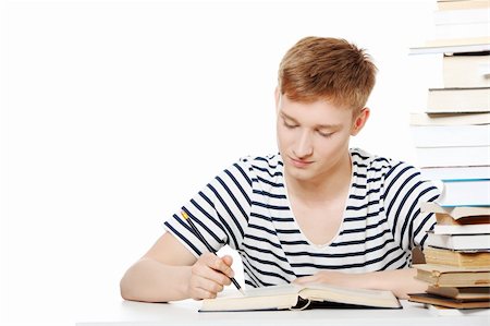 simsearch:400-04118366,k - Teen boy learning at the desk, isolated on white Photographie de stock - Aubaine LD & Abonnement, Code: 400-04389884