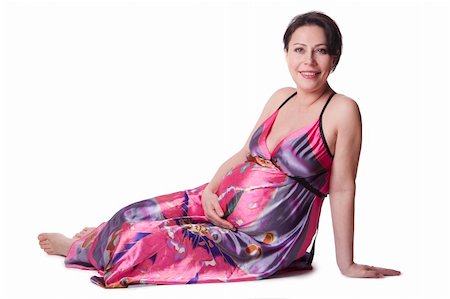 A pregnant woman lies in a beautiful dress isolated on white Foto de stock - Super Valor sin royalties y Suscripción, Código: 400-04380043