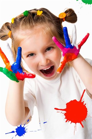 smiling girl with the palms painted by a paint. Isolated on white background Photographie de stock - Aubaine LD & Abonnement, Code: 400-04380764