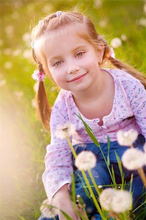 simsearch:400-06768635,k - Cute little girl  on the meadow in spring day Foto de stock - Royalty-Free Super Valor e Assinatura, Número: 400-04380770