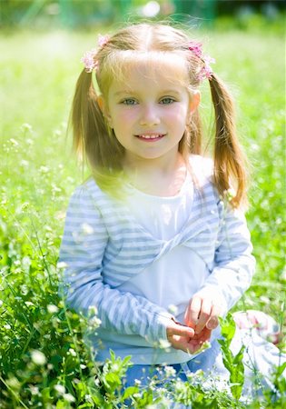 simsearch:400-06768635,k - Cute little girl  on the meadow in spring day Foto de stock - Royalty-Free Super Valor e Assinatura, Número: 400-04380773