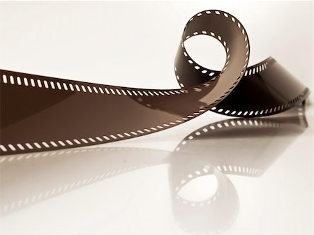 slightly rolled undeveloped film strip on a glossy surface Stock Photo - Budget Royalty-Free & Subscription, Code: 400-04380830