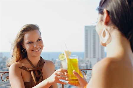young caucasian female couple drinking cocktails and smiling on terrace in Havana, Cuba. Horizontal shape, waist up, copy space Stock Photo - Budget Royalty-Free & Subscription, Code: 400-04381109