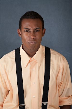 Young upset African-American male on gray background Stockbilder - Microstock & Abonnement, Bildnummer: 400-04382029