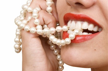 simsearch:400-05279995,k - woman smiles showing white teeth, holding a pearly necklace in to the mouth, teeth care concept Stockbilder - Microstock & Abonnement, Bildnummer: 400-04382136