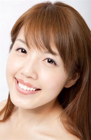 smiling beautiful asian woman's face with fresh clean skin Stock Photo - Budget Royalty-Free & Subscription, Code: 400-04382574