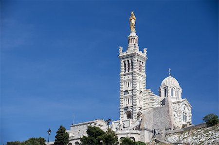 french riviera - Famous Notre-Dame-de-la-Garde on the hill in Marseille in France Foto de stock - Super Valor sin royalties y Suscripción, Código: 400-04382687