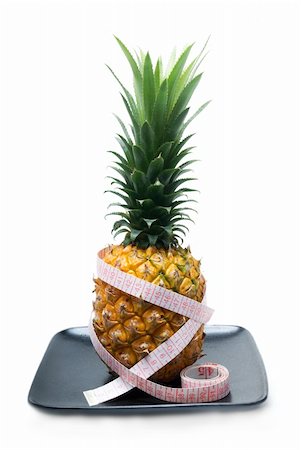 simsearch:400-04315300,k - pineapple on a black plate with tape meter isolated on white background Foto de stock - Super Valor sin royalties y Suscripción, Código: 400-04383213