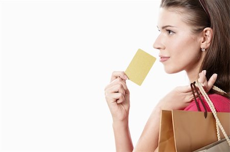 Young girl with a credit card and shopping bags on white background Stock Photo - Budget Royalty-Free & Subscription, Code: 400-04383783