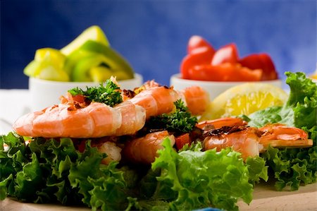 photo of delicious grilled prawns over lettuce bed with peperoni over blue background Stock Photo - Budget Royalty-Free & Subscription, Code: 400-04383929