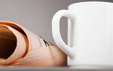 close-up view of white cup and folded newspaper Stock Photo - Budget Royalty-Free & Subscription, Code: 400-04383944