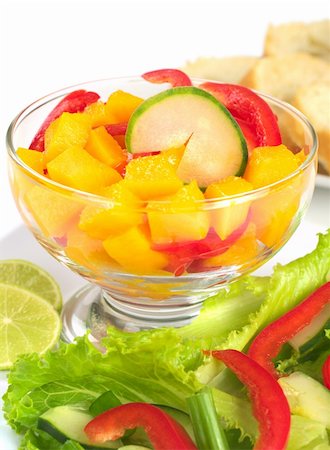 simsearch:400-04854606,k - Fresh salad of mango, red bell pepper, cucumber and lettuce (Selective Focus, Focus on the cucumber slice in  the bowl) Foto de stock - Royalty-Free Super Valor e Assinatura, Número: 400-04394330