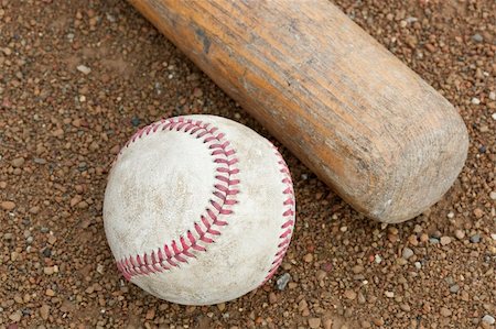 A worn baseball and bat on a baseball field Stock Photo - Budget Royalty-Free & Subscription, Code: 400-04394492