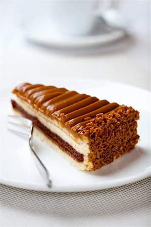 piece of delicious toffee cake, cup of coffee in background Stock Photo - Budget Royalty-Free & Subscription, Code: 400-04394929