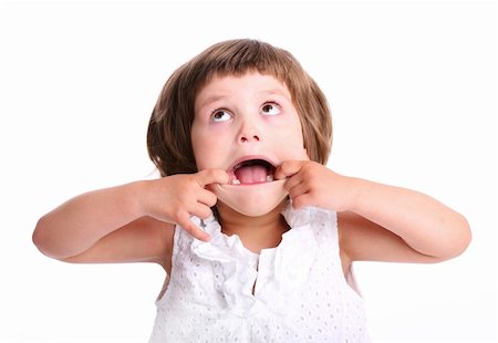 A portrait of a young adorable girl making faces over white background Stock Photo - Budget Royalty-Free & Subscription, Code: 400-04395538