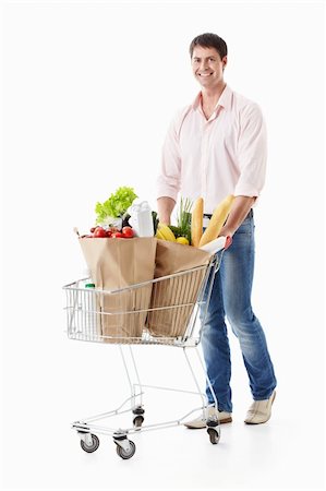 einkaufssüchtiger (männlich) - A young man with a cart with food on a white background Stockbilder - Microstock & Abonnement, Bildnummer: 400-04395972