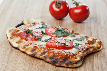 simsearch:400-07314797,k - Homemade margarita pizza with tomatoes, cheese, and basil Photographie de stock - Aubaine LD & Abonnement, Code: 400-04396264