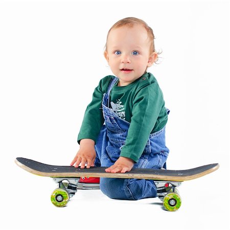 simsearch:400-05260723,k - Cute 1 years old boy on a skateboard in the studio Foto de stock - Super Valor sin royalties y Suscripción, Código: 400-04396511